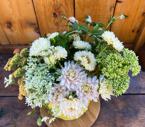 DIY Floral Bucket of whites, creams, yellows, and greens.